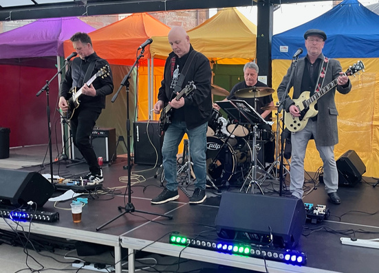 A band performing on the outdoor stage at Blast Off 2026