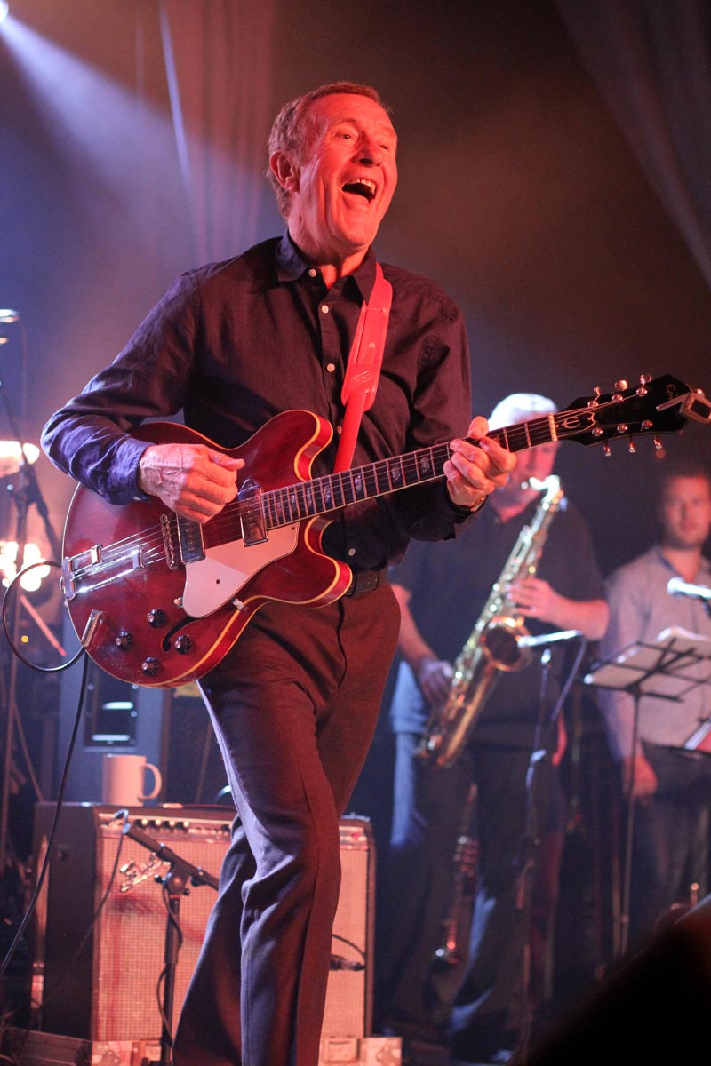 Hamish Stuart performing on stage in Darvel
